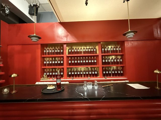 The finished bar on set — bottle wall lit, bar dressed